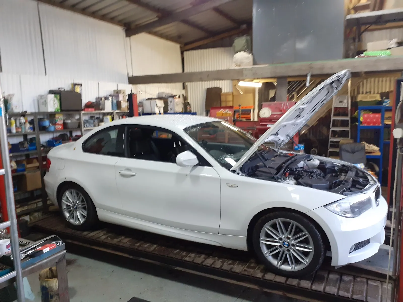 White BMW being worked on inside Bradley's Garage